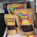 Three kraft pouches of Karkade dried hibiscus with window panels showing the deep red dried calyces inside, labelled Product of Sudan, packaged in Australia