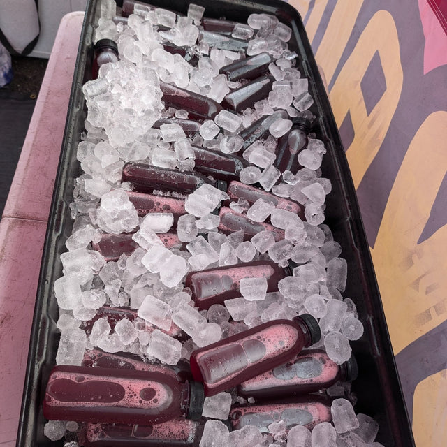 Bottles of Karkade hibiscus drink packed in ice